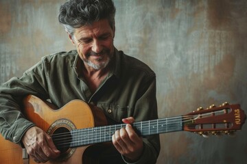Obraz premium Portrait of a satisfied man in his 50s playing the guitar while standing against minimalist or empty room background