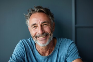 Obraz premium Portrait of a tender caucasian man in his 60s smiling at the camera on minimalist or empty room background