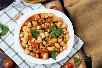 Lobio is a dish of Georgian, Azerbaijani and Armenian cuisines made from green bean pods. Traditional Georgian cuisine lobio. Lean dish. Lobio with pepper, onion. Top view. Flatlay