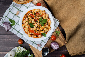 Lobio is a dish of Georgian, Azerbaijani and Armenian cuisines made from green bean pods. Traditional Georgian cuisine lobio. Lean dish. Lobio with pepper, onion. Top view. Flatlay
