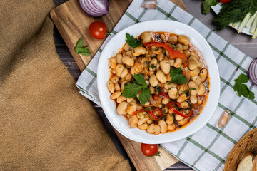 Lobio is a dish of Georgian, Azerbaijani and Armenian cuisines made from green bean pods. Traditional Georgian cuisine lobio. Lean dish. Lobio with pepper, onion. Top view. Flatlay