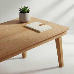 a wooden table with a notebook and a small plant, perfect for any home or office decor