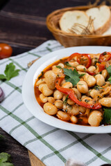 Lobio is a dish of Georgian, Azerbaijani and Armenian cuisines made from green bean pods. Traditional Georgian cuisine lobio. Lean dish. Lobio with pepper, onion. Side view.