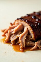 Close-up view of succulent, slow-cooked meat, glistening with a rich, flavorful glaze, delicately pulled apart and showcasing its tender texture