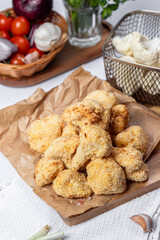 Cauliflower fries, lean dish, cauliflower in batter. Healthy fast food. Low-calorie food fries. Cabbage, tomatoes. Deep fryer. High quality photo.