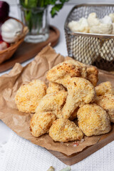 Cauliflower fries, lean dish, cauliflower in batter. Healthy fast food. Low-calorie food fries. Cabbage, tomatoes. Deep fryer. High quality photo.