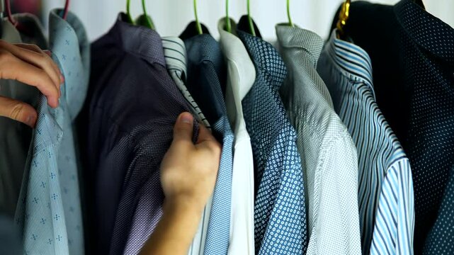 Closet with hanging business shirts in various patterns and colors