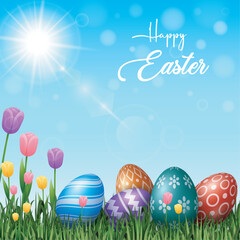 Colorful Easter eggs with flowers in the grass