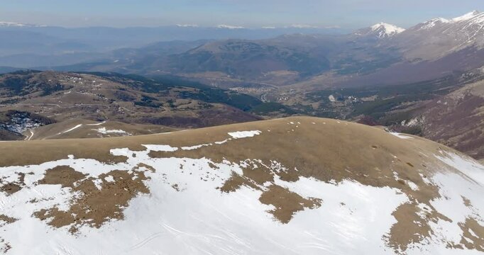 Aerial view of the small village of Assergi, hamlet of L'Aquila, Abruzzo, Italy. In the background the mountains.