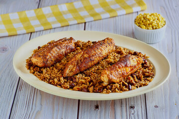 blackened monkfish served with dirty rice