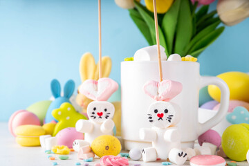Easter holiday  hot chocolate with funny bunny rabbits creative made with marshmallows, greeting...