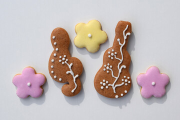 Romantic decorated gingerbread cookies in a shape of guitar, treble clef and flowers, white background. Musical theme