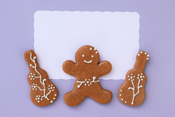 Romantic decorated gingerbread cookies in a shape of guitar and man, white space for text. Musical theme