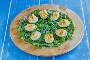 deviled eggs on a bed of arugula