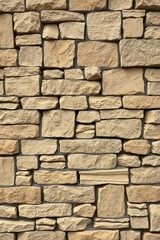 Obraz premium Stone Wall Texture Background Featuring Sandstone Blocks with Gray Mortar