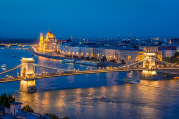 Aerial view of Budapest parliament and Chain bridge over Danube river at night, Hungary