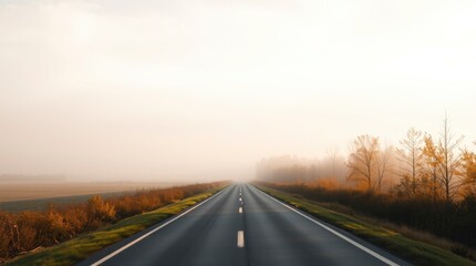 Fototapeta premium Driving on Empty Road Through Foggy Countryside with Autumn Colors