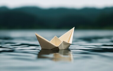 Paper boat floating on water surface with blurry background. Origami, hope, travel, adventure