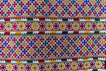 Hand-embroidered Yao Mien embroidery textile with colorful patterns, traditional tribal textile craft, intricate needlework, perfect for backgrounds, designs, and cultural art projects.