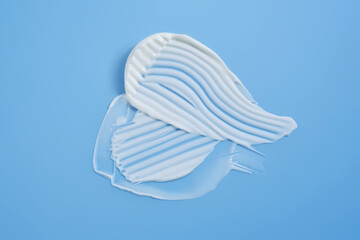 A smear of white cream on a blue background.