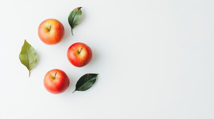 Three Red Apples and Leaves on White Background