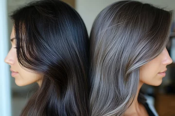 Selbstklebende Fototapeten Two women, back-to-back, showcasing contrasting hair colors dark and ash blonde. © Gogo