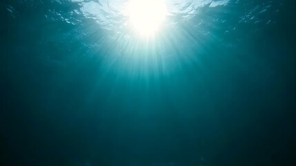 Fototapeta premium Underwater view with sun rays penetrating ocean waves