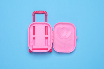 Miniature travel doll luggage on a blue background