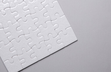 White blank square Jigsaw puzzle on gray background. Mockup for design
