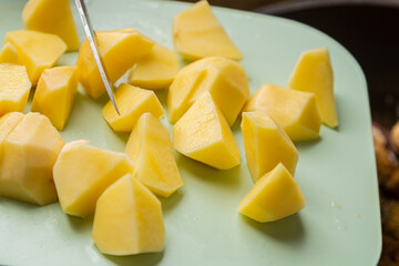 Prepared potato slices on a cutting board