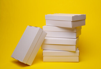 Stack of White cardboard boxes on a gray background