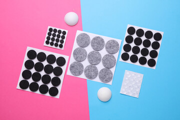 Felt protective circle pads for furniture on pink blue background