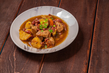 On the plate on the table is chelnt with potatoes