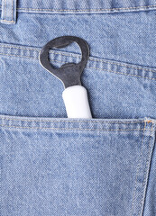Beer opener in the pocket of blue jeans