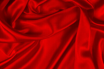Red silk or satin luxury fabric texture can use as abstract background. Top view.
