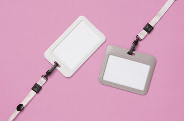 Blank plastic Id card badges with belt on pink background. Template for design