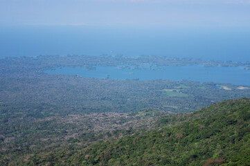 Scenic view of lush mountains overlooking serene blue lake at midday