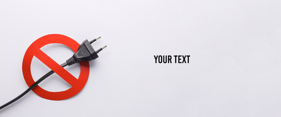 Electric plug with a prohibition sign on a white background. Copy space for your text and...