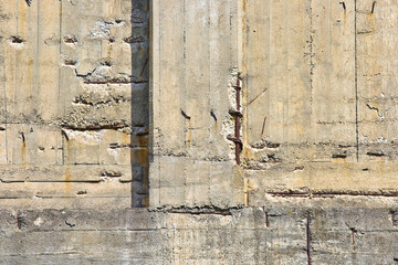 Old an damaged concrete wall with poor and damaged concrete cover and corrosion of reinforcement...
