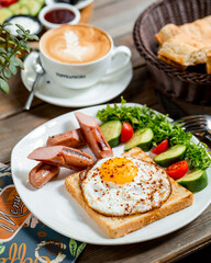 Breakfast with coffee and eggs, tomatoes and cucumbers