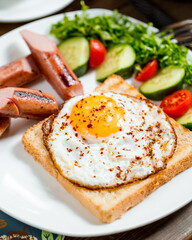 Breakfast with coffee and eggs, tomatoes and cucumbers