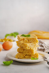 Spanish omelette with potatoes and onion, typical Spanish cuisine. Tortilla espanola. Omelet with eggs, potatoes and onion, authentic recipe. Rustic white background