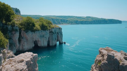 Coastal cliffs meet turquoise sea