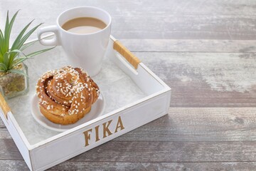 Cinnamon bun (kanelbulle) with coffee.Traditional Swedish fika.