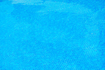 Clear water surface, ripple water in tiled swimming pool