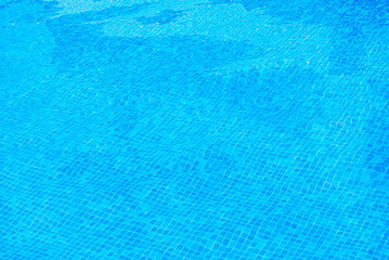 Clear water surface, ripple water in tiled swimming pool