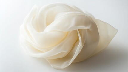 Cream-colored sheer fabric. Light reflects on folds, creating depth. Soft