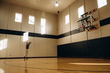 The basketball is hovering in the air on its way to the hoop, creating an atmosphere of tense...