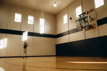The athlete turns sharply around an imaginary defender and makes a throw using balance and...