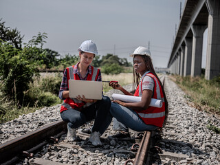 A female railway engineer sits on the tracks discussing her problems. Her coworker agrees to the...
